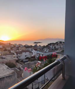 a view from a balcony of a city at sunset at Joni Apartments in Ksamil