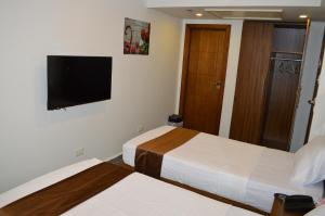 Postel nebo postele na pokoji v ubytování Royal Inn Residence