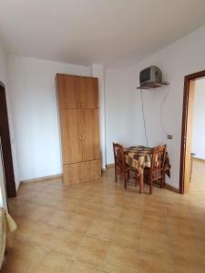 a dining room with a table and chairs and a cabinet at Hotel Bora 