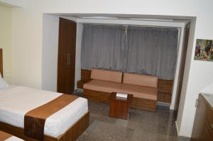 Postel nebo postele na pokoji v ubytování Royal Inn Residence