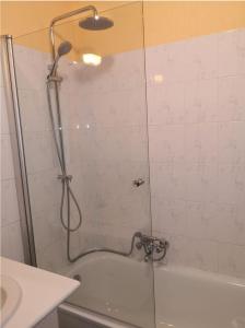 a shower with a glass door in a bathroom at Zonnig Appartement Golf van Durbuy in Durbuy