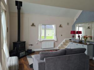 a living room with a couch and a stove at The Grove in Belturbet