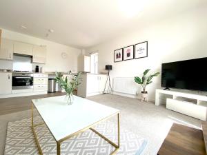 uma sala de estar com uma mesa branca e uma televisão em Home Crowd Luxury Apartments em Doncaster