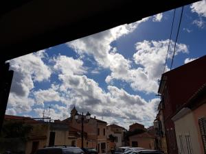 a view of a cloudy sky from a street at stupenda casetta in centro storico in La Maddalena