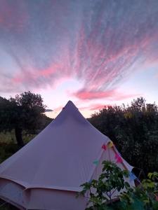 a white tent in front of a sunset at Hidden Valley Andalucia in Alora