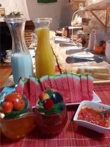 
a table topped with bowls of fruit and vegetables at Hidden Valley Andalucia in Alora
