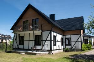 a house with a black and white at Anna Maria II in Jastrzębia Góra