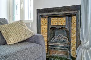 a fireplace in a living room with a couch at Casa Checca e Casa Maria appartamenti per vacanze in Caprarola