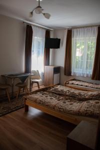 a hotel room with two beds and a desk at Anna Maria II in Jastrzębia Góra