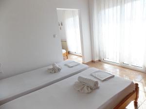 Postel nebo postele na pokoji v ubytování Hotel Sgouridis