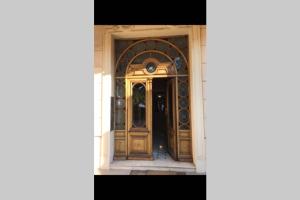 an open door of a house with a wooden door at charmant studio bord de mer in Menton