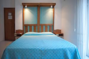 Postel nebo postele na pokoji v ubytování Albergo Miramare
