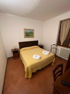 a bedroom with a bed with two towels on it at Al Vecchio Camino in Rotonda