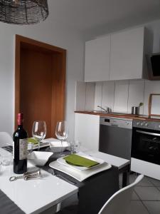 a kitchen with a table with a bottle of wine at Apartement am Waldrand in Bad Wildbad