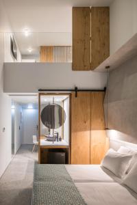 a bedroom with a large white bed and a desk at Sensus Experience by Lavris in Gouves