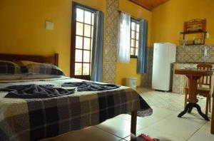 Łóżko lub łóżka w pokoju w obiekcie Pousada Vila Paolino