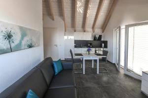 a living room with a couch and a table at Apartment Müller am See in Immenstaad am Bodensee
