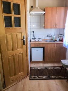 a kitchen with a wooden door and a sink at Anna Maria II in Jastrzębia Góra