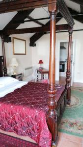 a bedroom with a large bed with a wooden frame at Annie's in Carlisle