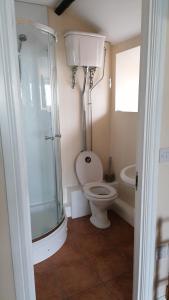 a bathroom with a toilet and a glass shower at Annie's in Carlisle