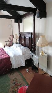 a bedroom with a bed and a table with a lamp at Annie's in Carlisle