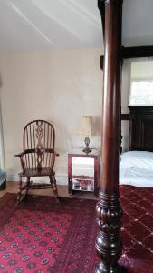 a bedroom with a bed and a chair and a table at Annie's in Carlisle