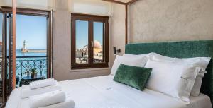 a bedroom with a bed with a view of the ocean at Anassa Chania Boutique Hotel in Chania Town