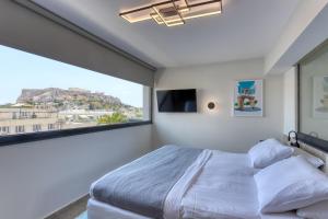 Postel nebo postele na pokoji v ubytování Athens Ivy Suites