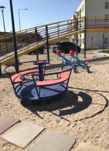 a swing set on a playground in the sand at Departamento Portal Caldera in Caldera