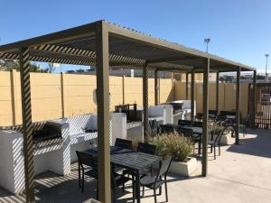 a patio with tables and chairs under a pavilion at Departamento Portal Caldera in Caldera