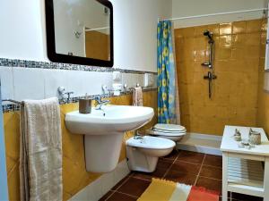 Lu Purpu di Casa Camilla Journey في مارينا سيرا: حمام مع حوض ومرحاض ومرآة