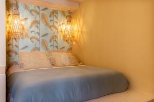 una camera con un letto con due cuscini sopra di Le Saint Victor Coeur de Cannes a Cannes