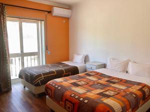 Uma cama ou camas num quarto em Alojamento Local S. Bartolomeu