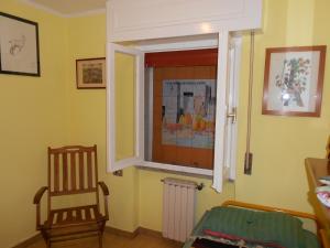 a room with a chair and a window at VISTA PANORAMICA in Castiglione della Pescaia