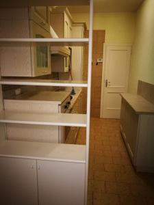 a kitchen with white cabinets and a white door at VISTA PANORAMICA in Castiglione della Pescaia