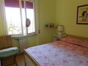 a bedroom with a bed and a window at VISTA PANORAMICA in Castiglione della Pescaia