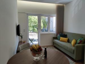 a living room with a table and a couch at Suite na baixa do Porto in Porto