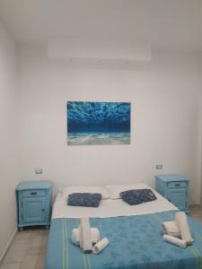 a bedroom with a bed and two blue night stands at Casa in borgo marinaro in Giardini Naxos