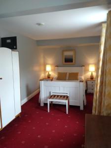 a bedroom with a white bed and two lamps at The Rio in Galway
