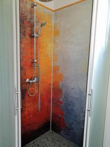 a shower with a glass door in a bathroom at A Casa Aperta in Favalello