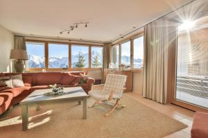 a living room with a couch and a table at Topas 7 in Bettmeralp