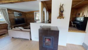 a living room with a fireplace and a television at Appartements "Da Zillertaler und die Geigerin" in Mayrhofen +54 photos