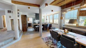 a dining room and living room with a table and chairs at Appartements "Da Zillertaler und die Geigerin" in Mayrhofen