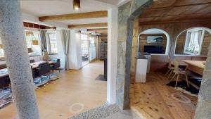 a living room with a kitchen and a dining room at Appartements "Da Zillertaler und die Geigerin" in Mayrhofen