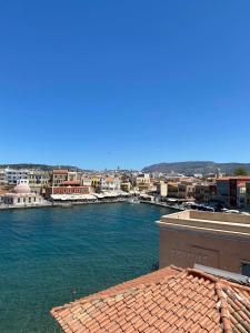 a view of a river with a city in the background at Helena Hotel in Chania Town