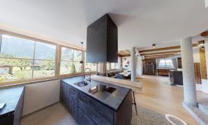 a kitchen with a sink and a large window at Appartements "Da Zillertaler und die Geigerin" in Mayrhofen