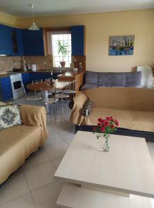 a living room with a couch and a table at Evi's Apartment in Lefkada Town