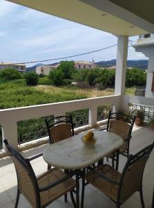 a table and chairs on a balcony with a view at Evi's Apartment in Lefkada Town