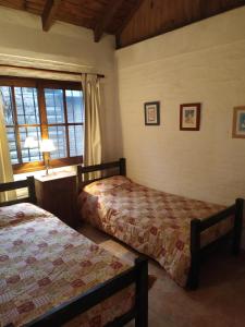 1 dormitorio con 2 camas y ventana en Casa Roja en Playa Verde