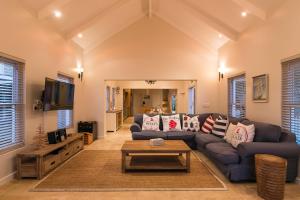 a living room with a couch and a table at Avocet Nest on Thesen Island in Knysna
